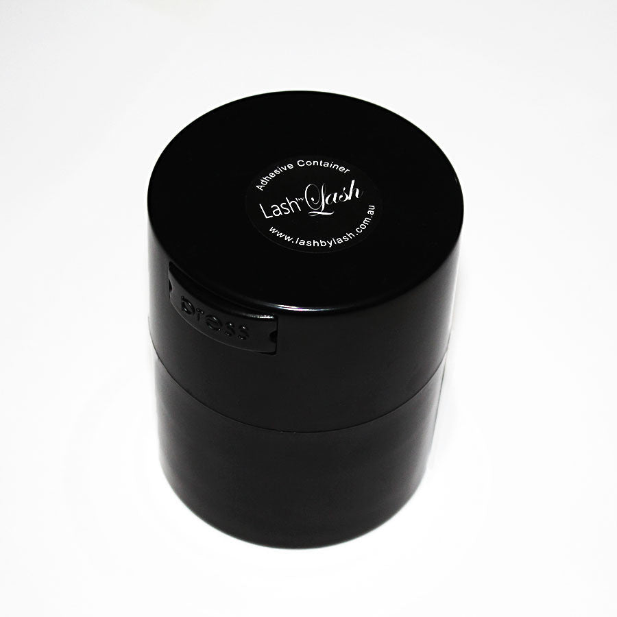 A black adhesive storage container with a vacuum seal, labelled 'Lash by Lash'.
